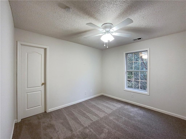 empty room featuring carpet flooring, ceiling fan, and a textured ceiling