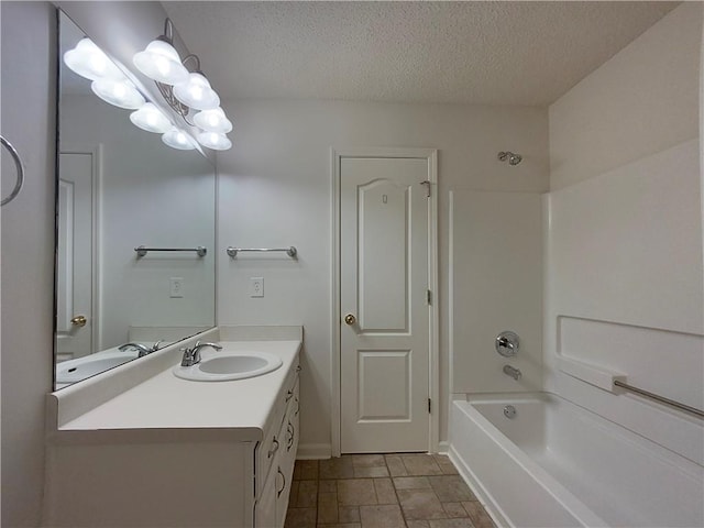 bathroom featuring vanity, shower / bathing tub combination, a textured ceiling, and a chandelier