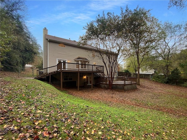 rear view of property with a wooden deck