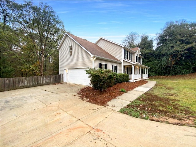 view of home's exterior with a yard, a porch, and a garage