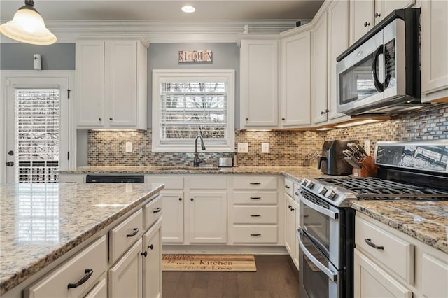 kitchen with white cabinetry, sink, hanging light fixtures, light stone counters, and stainless steel appliances