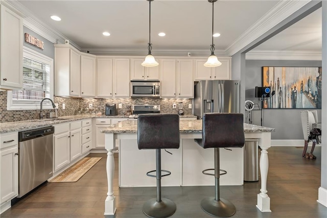 kitchen with pendant lighting, stainless steel appliances, and a kitchen island