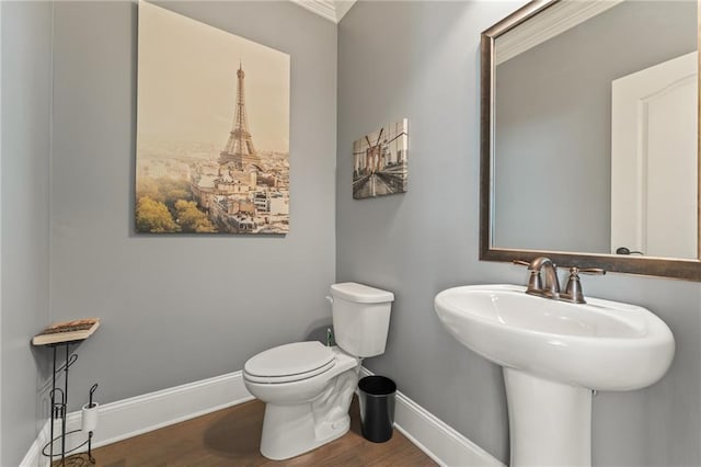 bathroom featuring sink, hardwood / wood-style floors, and toilet