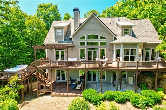 back of house with a patio area, a deck, and french doors