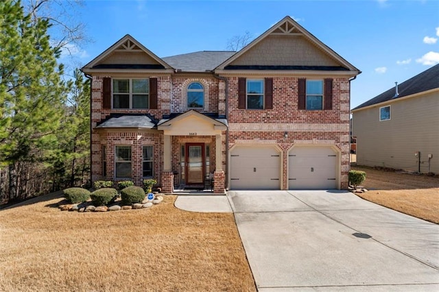 craftsman-style home featuring a garage and a front yard