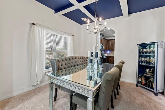 dining room with light carpet, a notable chandelier, beam ceiling, and coffered ceiling