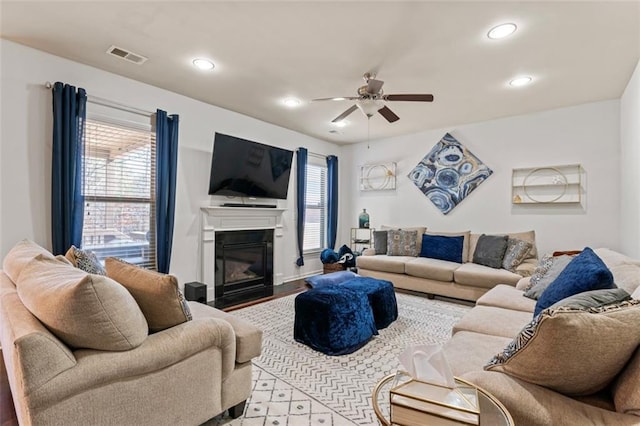 living room featuring ceiling fan and light wood-type flooring