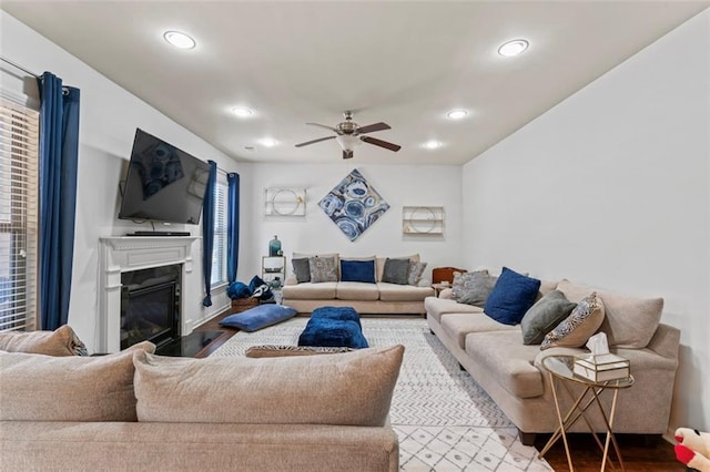 living room featuring ceiling fan and wood-type flooring