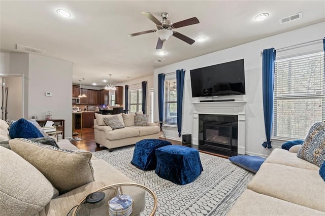 living room with hardwood / wood-style flooring, plenty of natural light, and ceiling fan