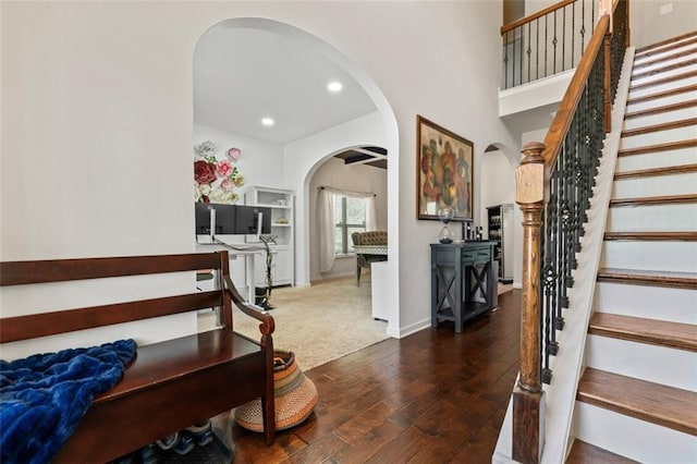 staircase with hardwood / wood-style floors