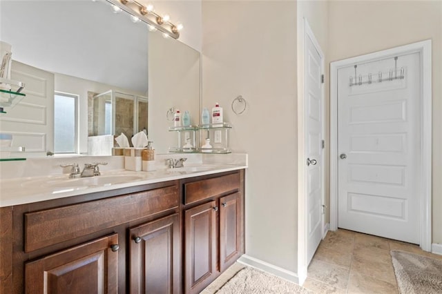 bathroom with vanity and a shower with door