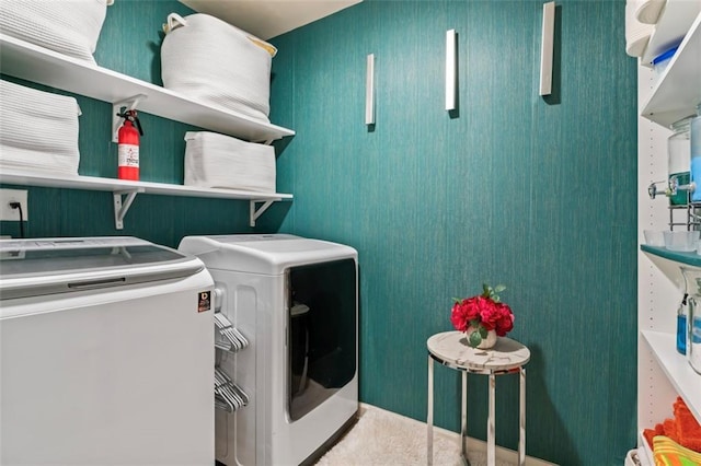 clothes washing area with washer and dryer