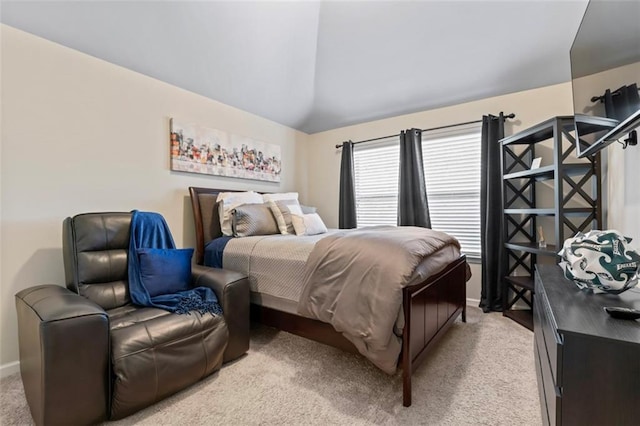 bedroom with lofted ceiling and light carpet