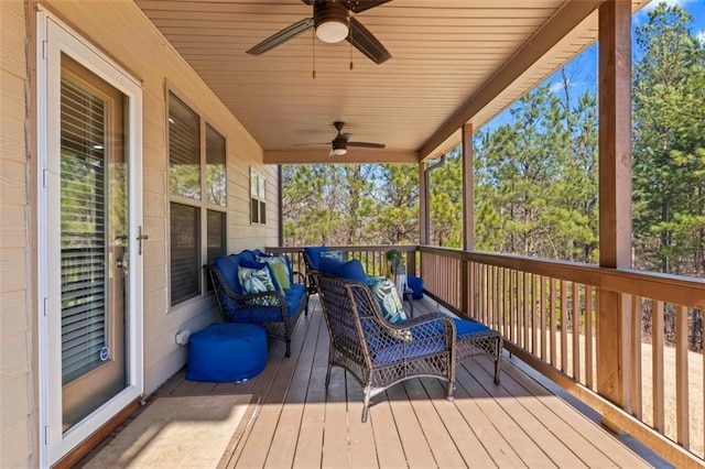 wooden terrace featuring outdoor lounge area and ceiling fan