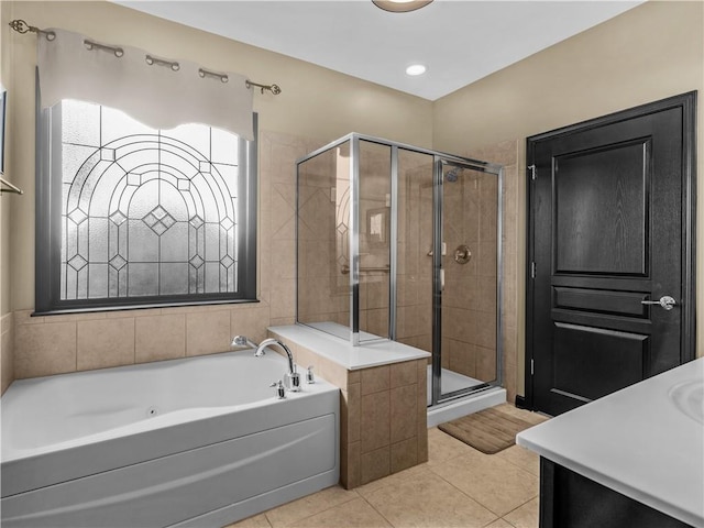 full bath featuring a stall shower, tile patterned flooring, and a garden tub