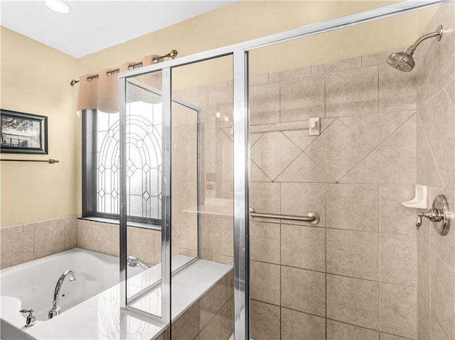 full bath featuring a stall shower, plenty of natural light, and a tub with jets