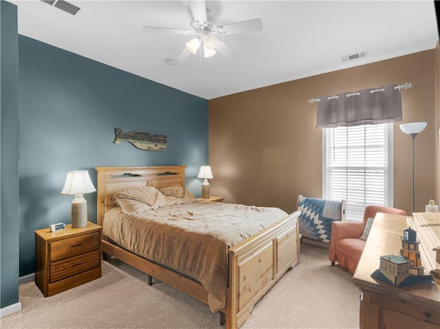 bedroom with light carpet, visible vents, and a ceiling fan