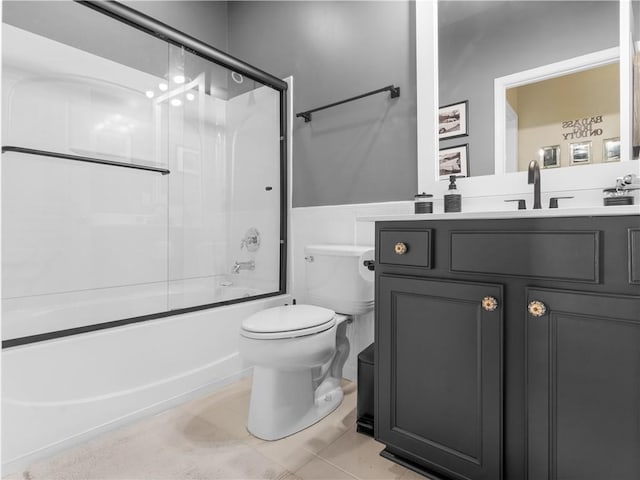 full bathroom featuring enclosed tub / shower combo, vanity, tile patterned flooring, and toilet