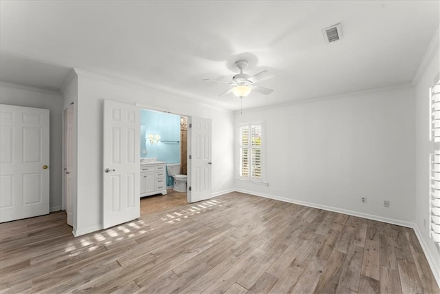 unfurnished bedroom featuring crown molding, ensuite bath, light hardwood / wood-style floors, and ceiling fan