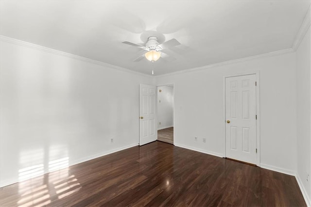 empty room with crown molding, dark hardwood / wood-style floors, and ceiling fan