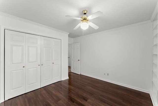 unfurnished bedroom with a closet, crown molding, dark hardwood / wood-style floors, and ceiling fan