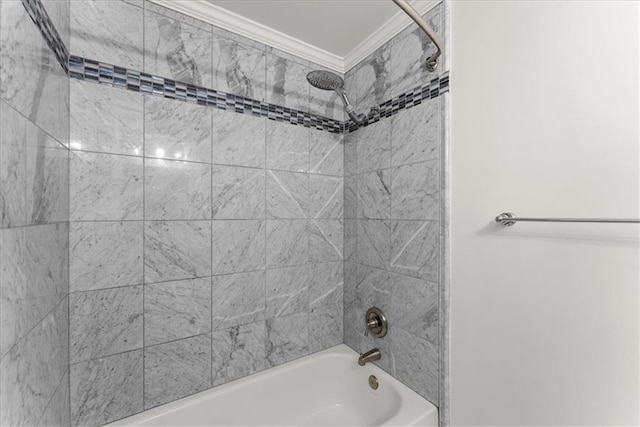 bathroom with tiled shower / bath combo and crown molding