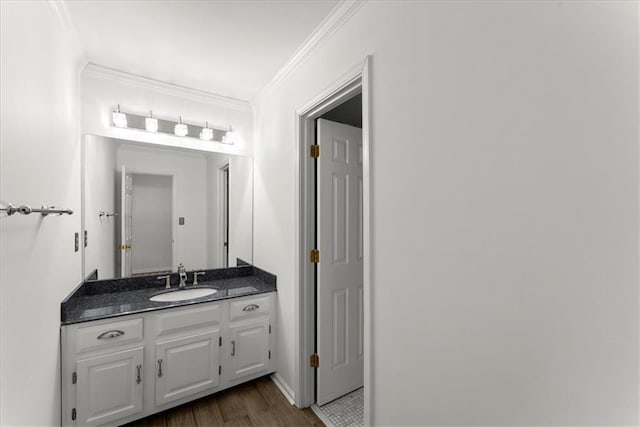 bathroom featuring vanity, hardwood / wood-style floors, and crown molding