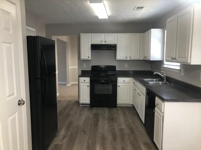 kitchen featuring white cabinetry, dark hardwood / wood-style floors, sink, and black appliances