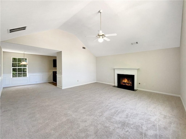 unfurnished living room with ceiling fan, light colored carpet, and vaulted ceiling