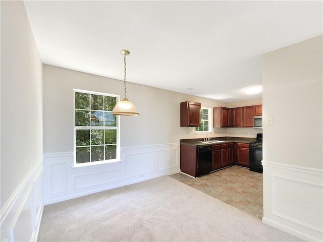 kitchen featuring light carpet, pendant lighting, a wealth of natural light, and black appliances