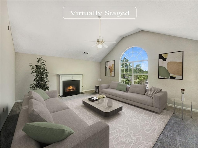 carpeted living room featuring ceiling fan and vaulted ceiling