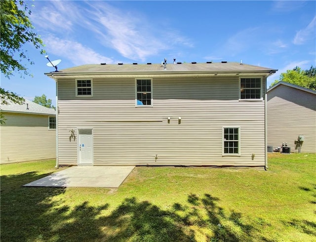 back of property with central air condition unit, a patio area, and a yard