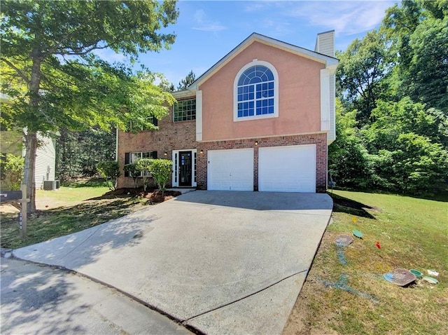 view of front of house featuring a front lawn, a garage, and cooling unit