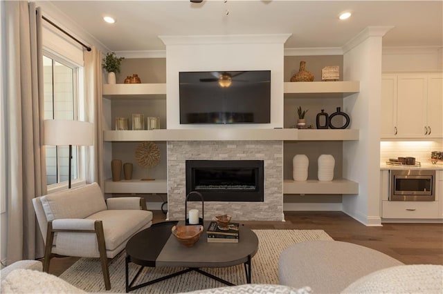 4923 Sudbrook Way Unit 233, Peachtree Corners, GA 30092 - living room featuring ornamental molding, dark wood-type flooring, ceiling fan, a stone fireplace, and recessed lighting