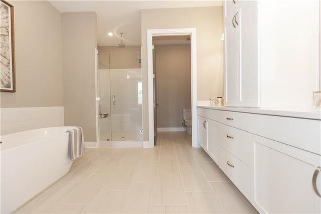 4923 Sudbrook Way Unit 233, Peachtree Corners, GA 30092 - full bath with a stall shower, a freestanding tub, vanity, recessed lighting, and tile patterned flooring