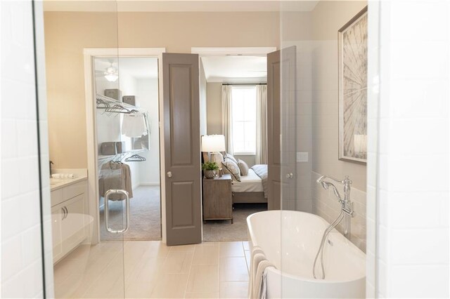 4923 Sudbrook Way Unit 233, Peachtree Corners, GA 30092 - ensuite bathroom featuring a freestanding bath, vanity, and tile patterned flooring