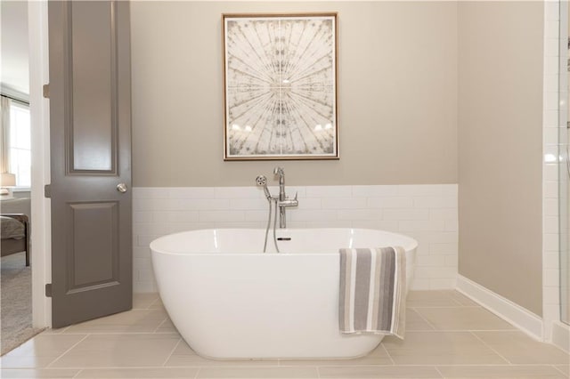 4923 Sudbrook Way Unit 233, Peachtree Corners, GA 30092 - bathroom with tile patterned floors, tile walls, a freestanding bath, and wainscoting