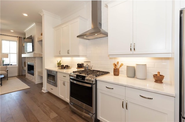 4923 Sudbrook Way Unit 233, Peachtree Corners, GA 30092 - kitchen with wall chimney exhaust hood, appliances with stainless steel finishes, tasteful backsplash, dark wood finished floors, and crown molding