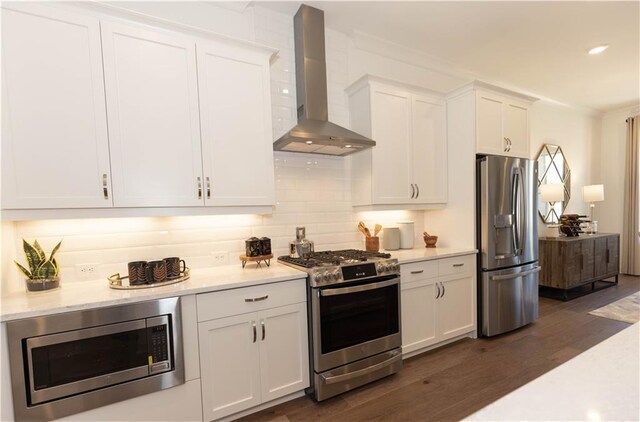 4923 Sudbrook Way Unit 233, Peachtree Corners, GA 30092 - kitchen featuring stainless steel appliances, wall chimney exhaust hood, dark wood-type flooring, white cabinets, and backsplash