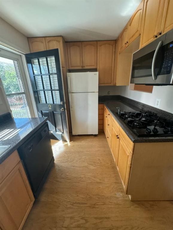 kitchen featuring black appliances and dark stone counters