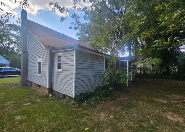 view of side of property with a lawn