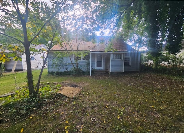 rear view of house with a yard