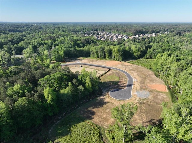 aerial view of property and surrounding area with a forest