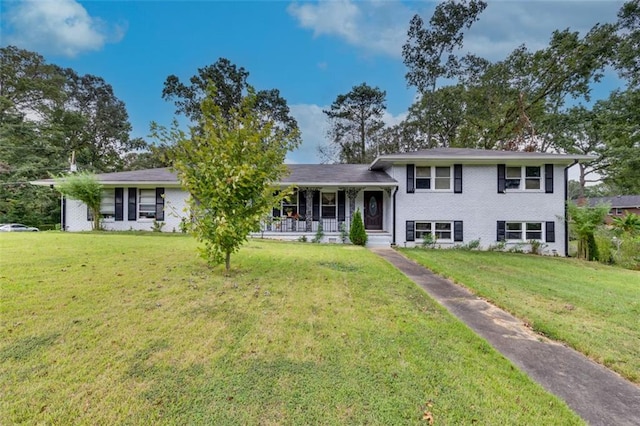 split level home with a front yard and covered porch