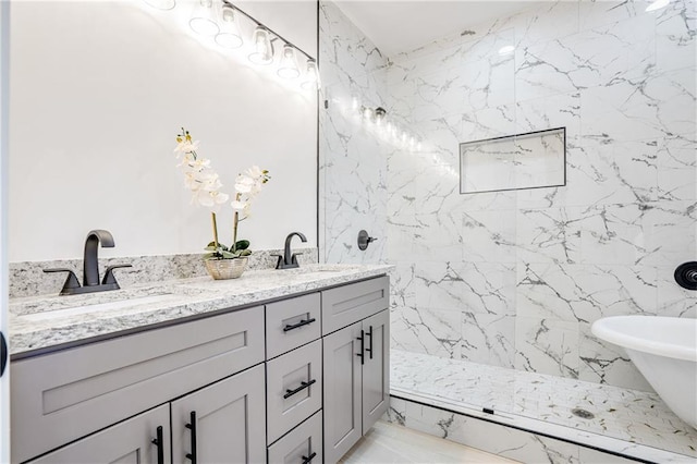 bathroom with vanity and a tile shower