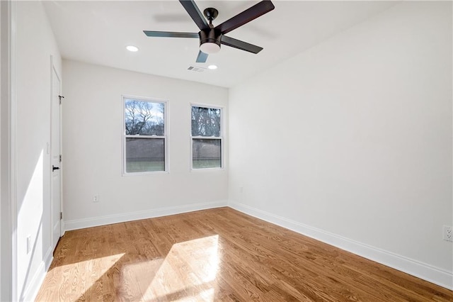 spare room with ceiling fan and light wood-type flooring