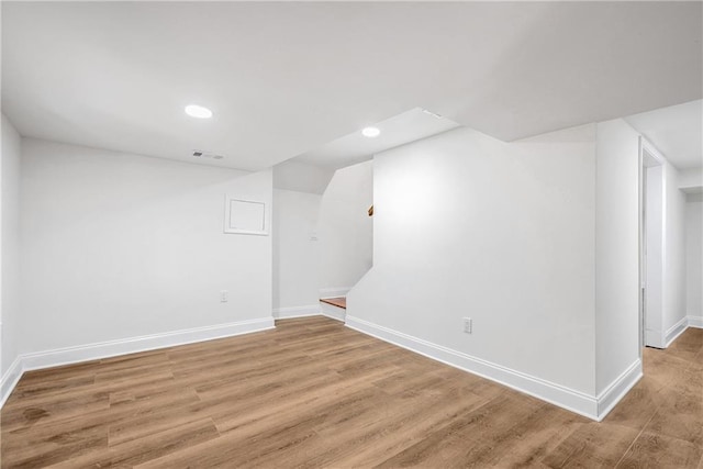 additional living space with wood-type flooring