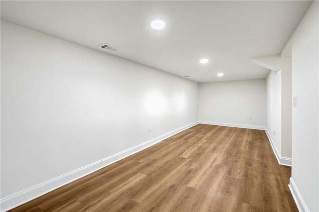 unfurnished room with hardwood / wood-style flooring