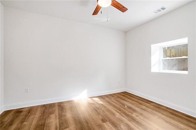 empty room featuring ceiling fan and hardwood / wood-style floors