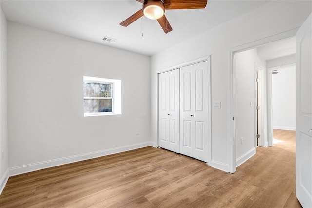 unfurnished bedroom with ceiling fan, a closet, and light hardwood / wood-style flooring